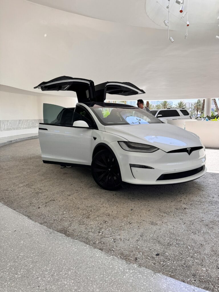 White Tesla car opening its door