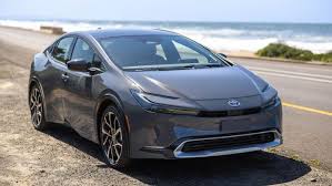 Toyota Prius Prime on grey color. ( parking on the side of Highway.)