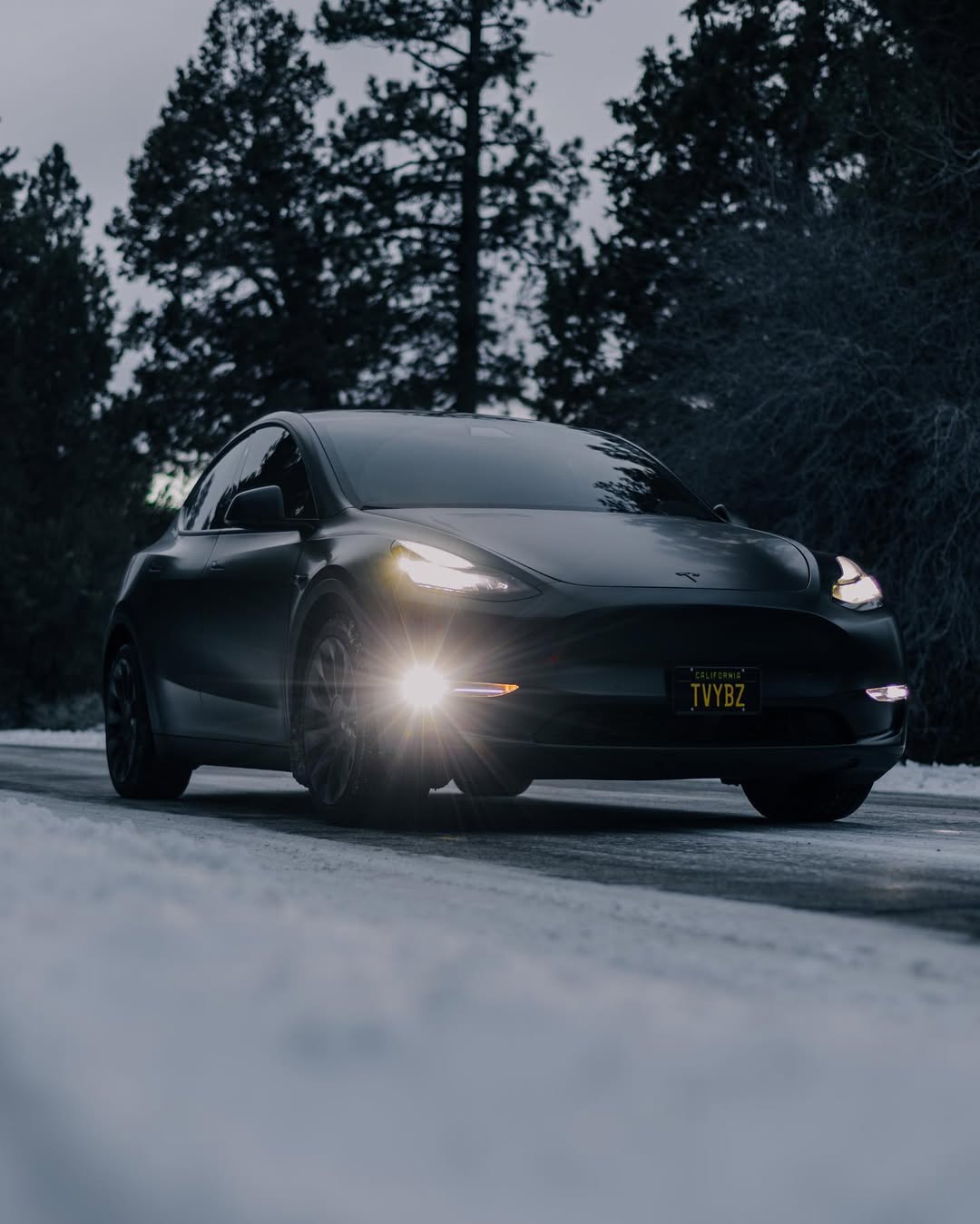 Black Tesla Car on Snow road