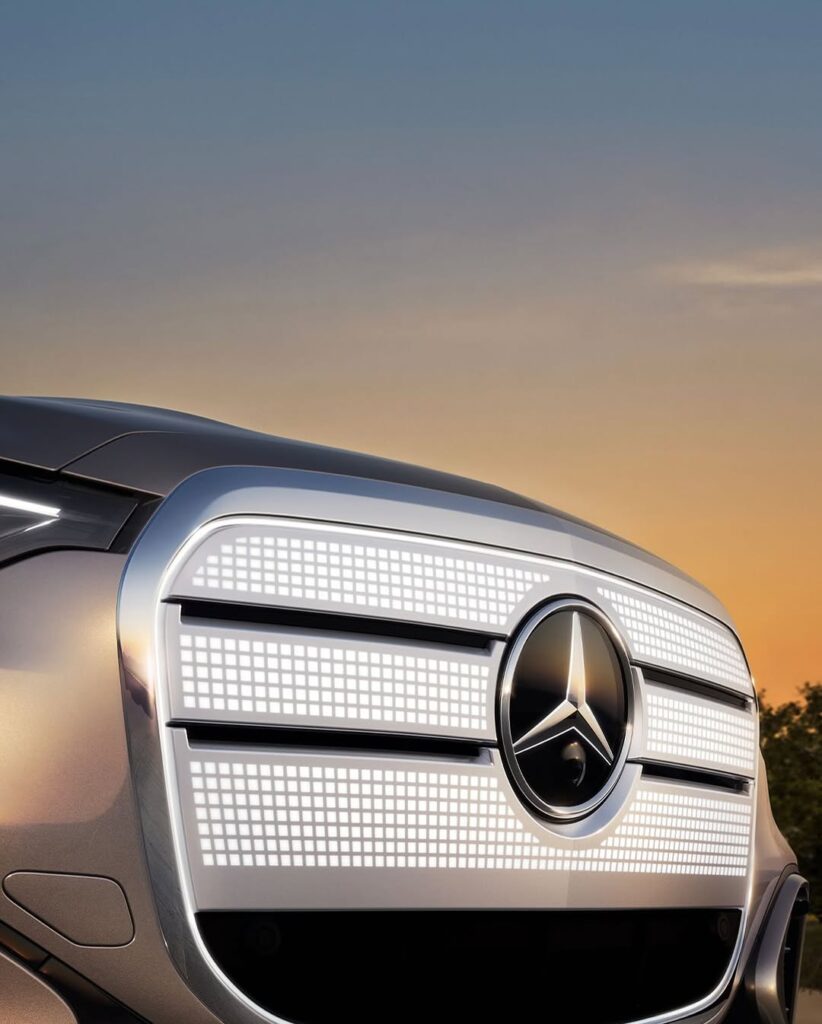 Mercedes-Benz C-Class on grey and white color showing car logo of its front part.