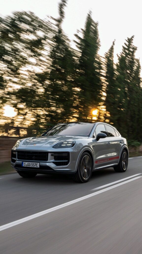 Silver Porsche Cayenne Driving Down the road