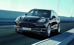 Black Porsche car running down the road 